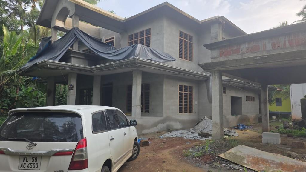 Two-storey residential house under construction with plastered walls